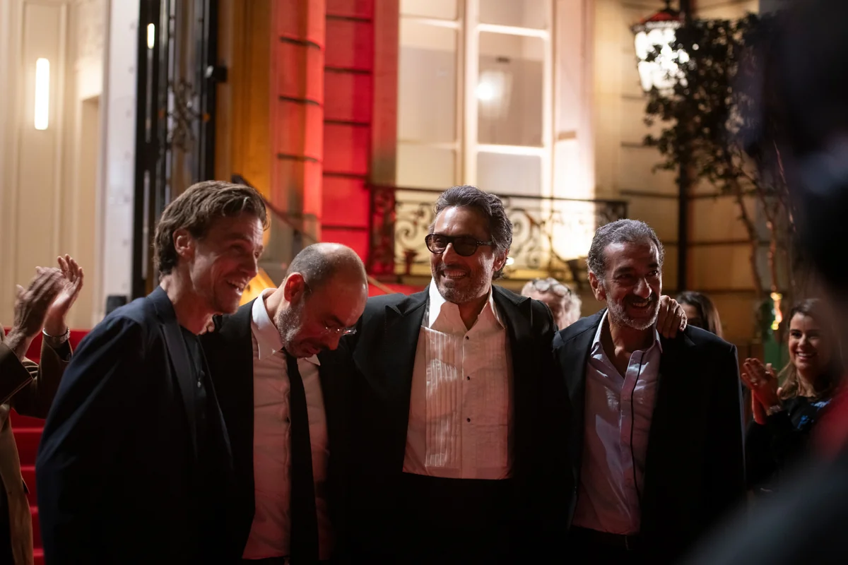 Guests gathered at the entrance to an illuminated building.