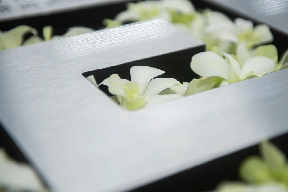 White flowers around a fragrance display.