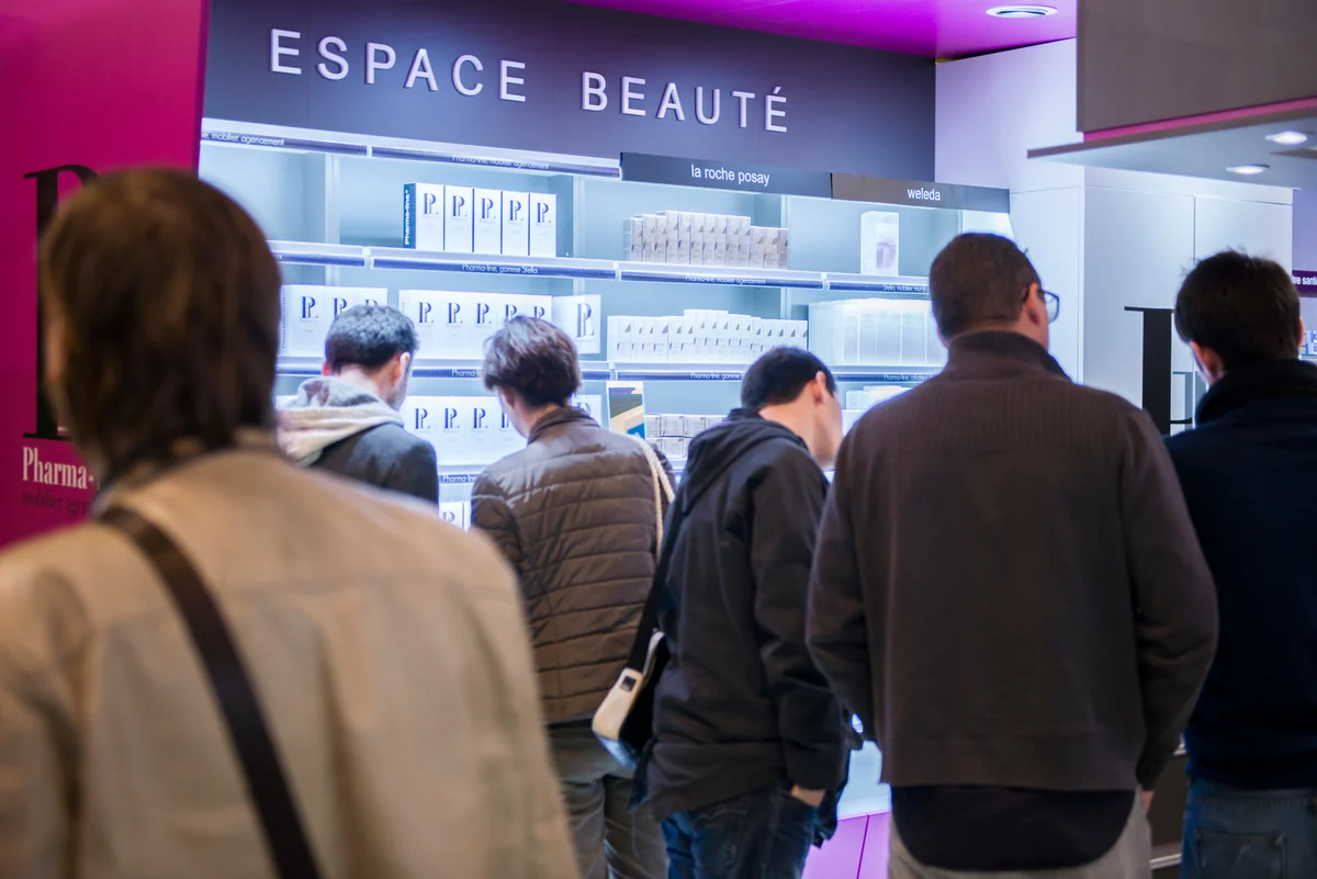 Visitors in front of the Espace Beauté displays.