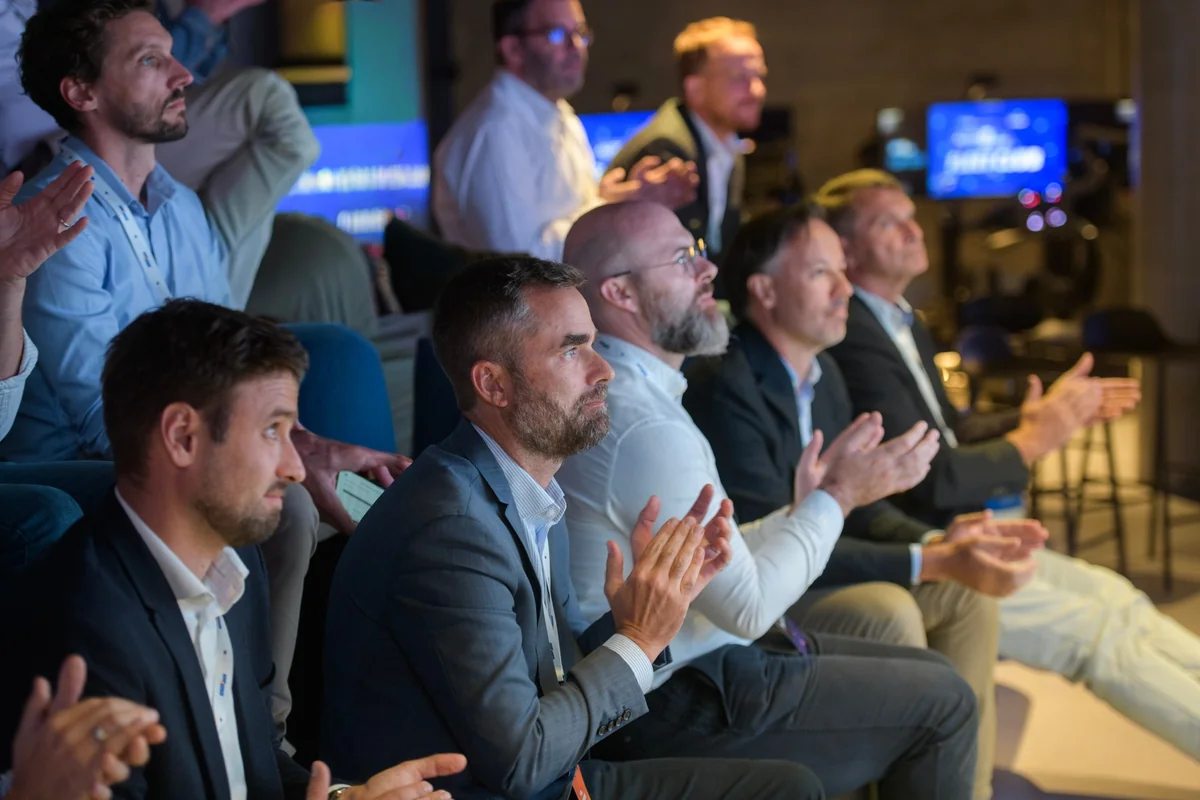 Attendees applaud from the tiered seating.