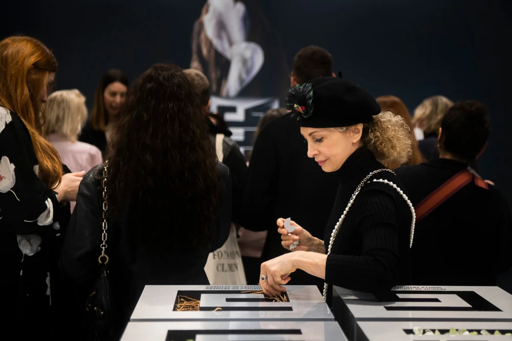 A visitor looks through documents on a table.