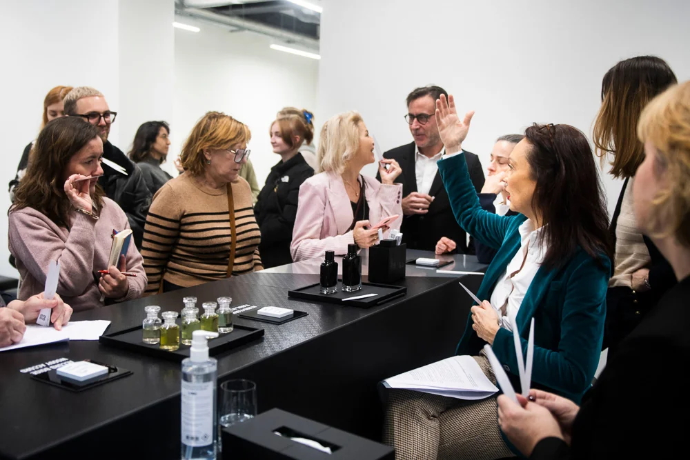 Visitors talk around a presentation table.