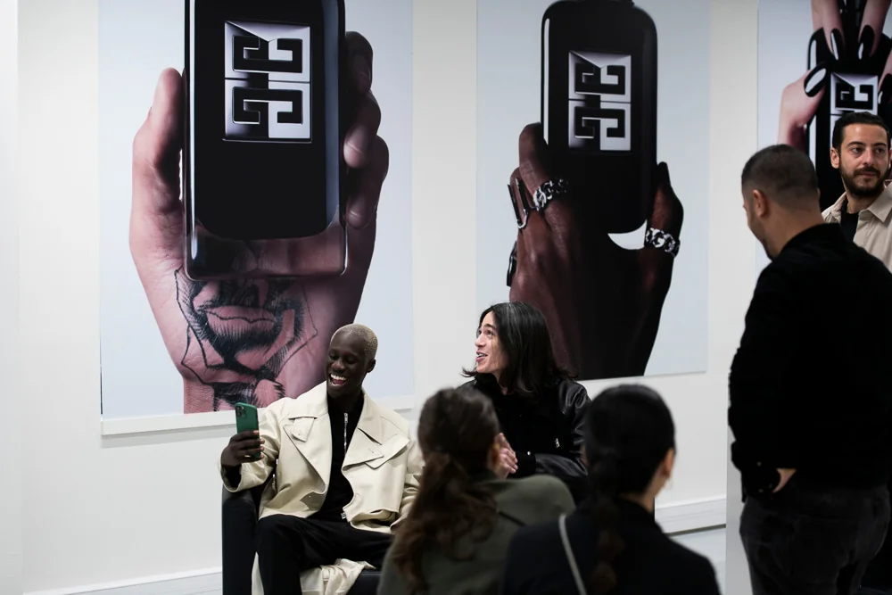 A group visits a Givenchy fragrance presentation area.