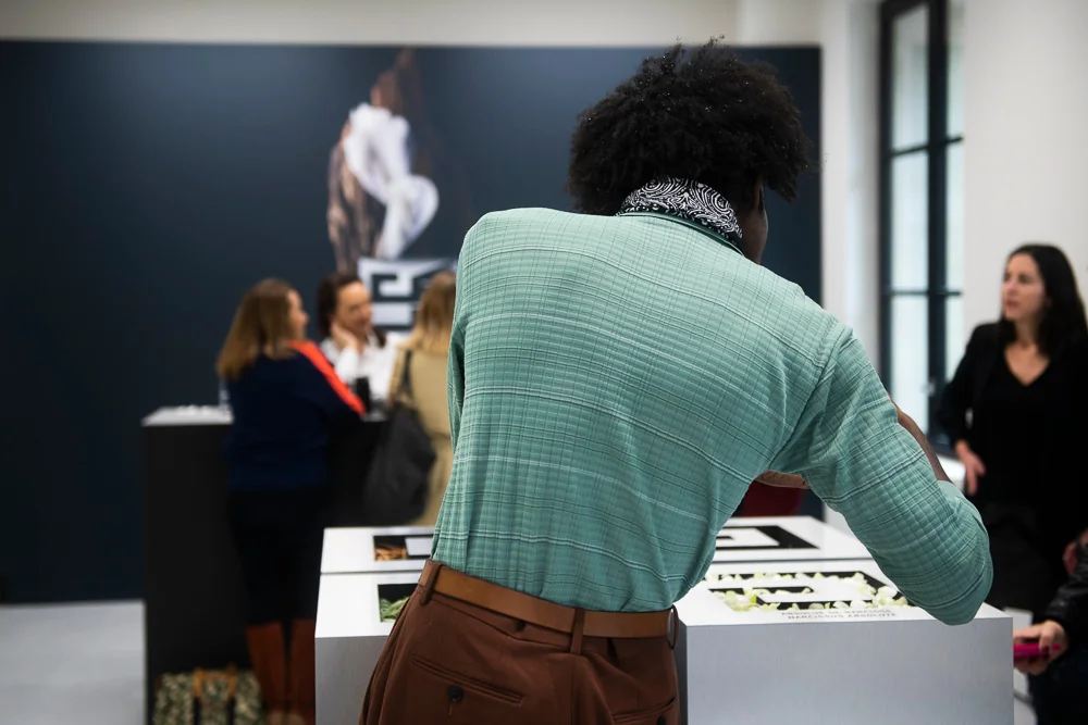 A man in front of the fragrance display table.