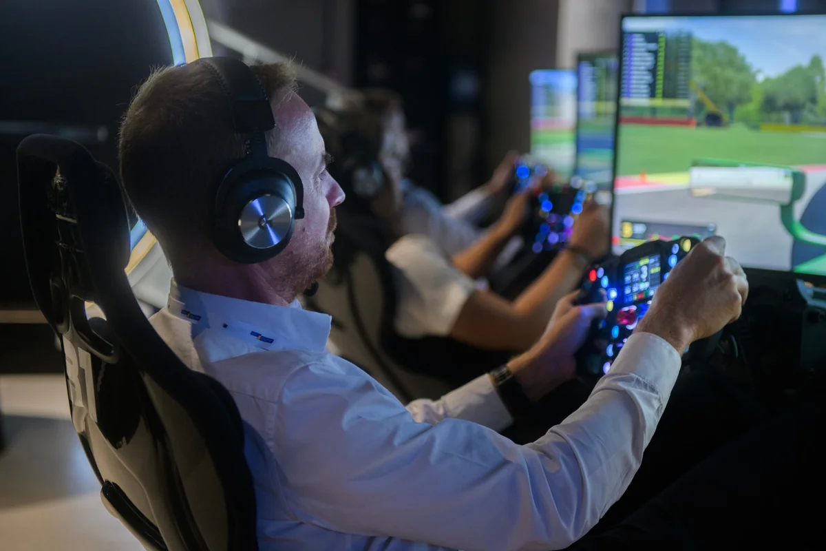 An attendee uses a driving simulator.
