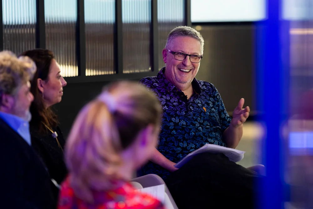 A smiling attendee during a group discussion.