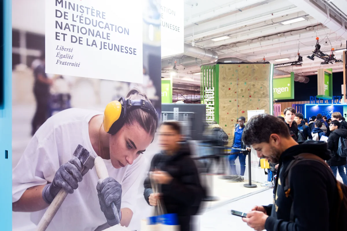 Visitors at an exhibition stand during a Paris trade show